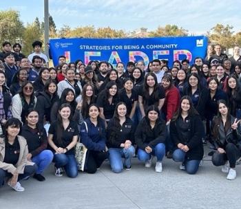 Crowd of Fellows with a "Leadership" banner in the background