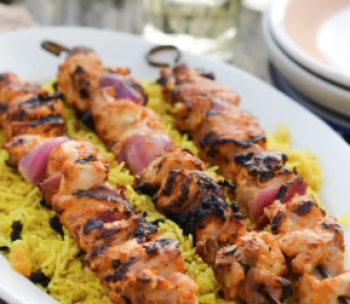 image of grilled chicken kabobs on a bed of rice pilaf