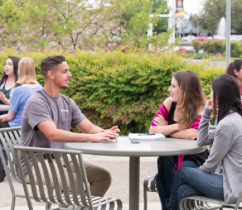Three students gathered at a table.