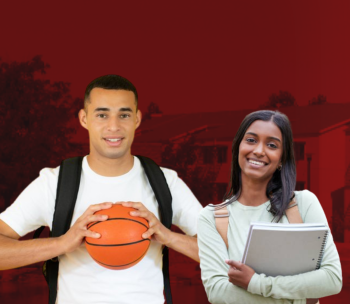 Two student posed in front of the Housing and Residential Life area.