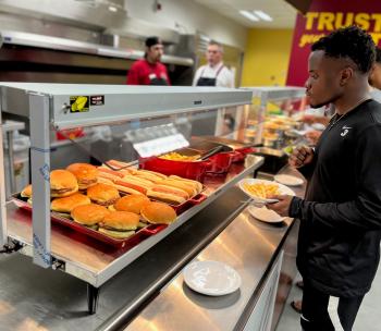 student standing by main dining counter