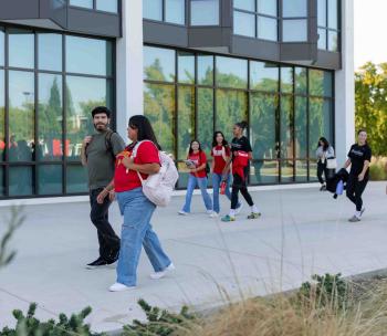 Students walking by University Library.