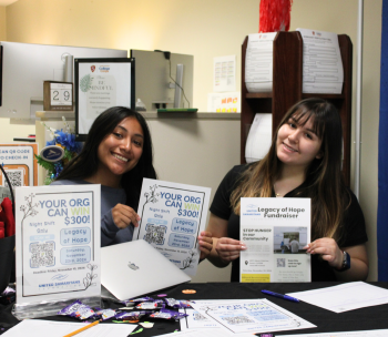 2 Fellows tabling in the College Corps office for the annual Legacy of Hope event