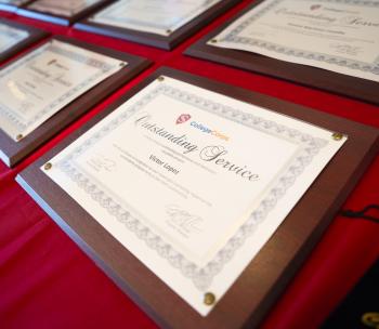 Outstanding Service Awards laid out on a table with a red table cloth. 