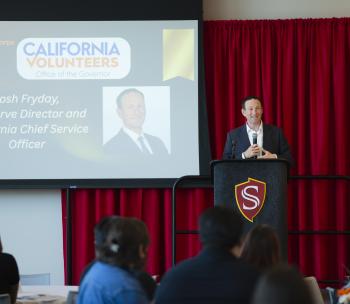 Josh Fryday, CA Chief Service Officer speaking at the College Corps End of the Year Ceremony