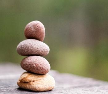 four stones stacked on a table
