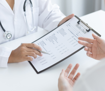 Healthcare provider overviewing health exam. 