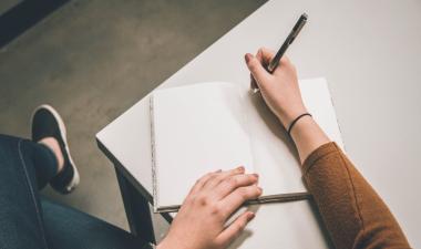 student writing in notebook