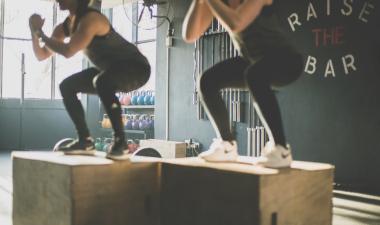 Two women doing box squats.