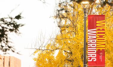 Welcome Warriors banner on campus