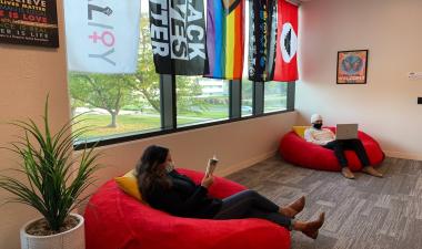Two students sitting on bean bag chairs.