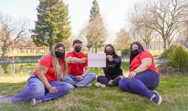 Stan State students with sign that reads &quot;#You are not alone&quot;.