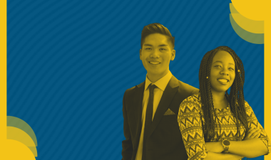 Two students posing for a picture. Blue and yellow background