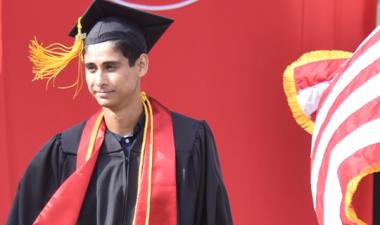 Graduate walks across the stage.