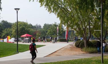 Student walking on Stan State campus.