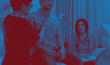 Nursing student in an exam room with two others.