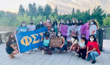 People gathered with sorority signs