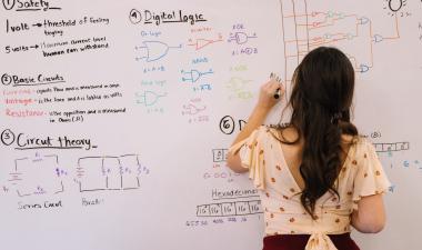 Woman writing on a board