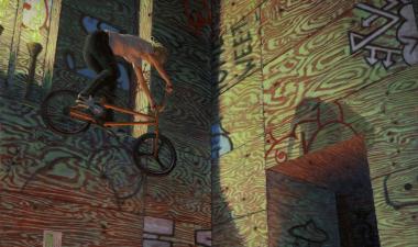 Man riding a bike mid-air, walls are covered in writing