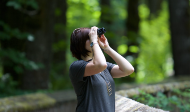 student looking through binoculars