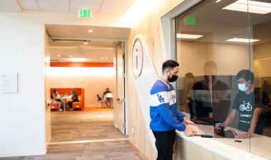 Student receiving a laptop from OIT