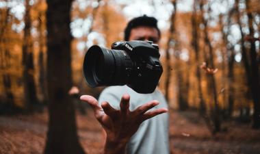 Someone throwing a camera in the air