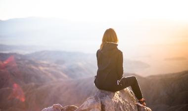 woman standing on cliff