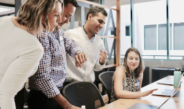 group of employees around a desk