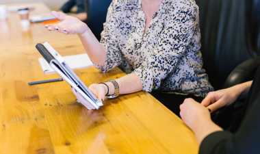 women holding a tablet in a meeting