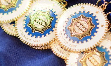 Phi Kappa Phi medallions on a table.