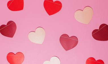 Pink and red hearts spread across a pink background