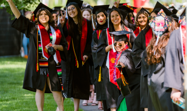Graduates lined up in their cap and gown.