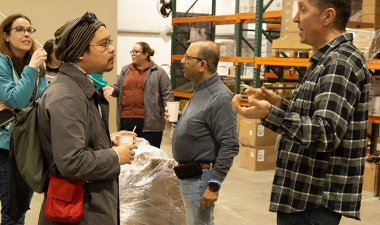 Marketing students visit a warehouse for a class project.