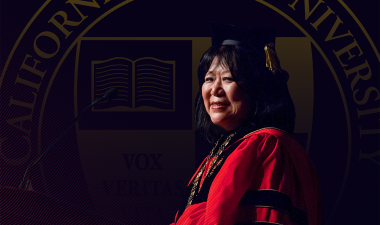 President Junn at podium in regalia.