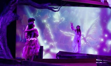 Student actors on stage with set, costume and lights