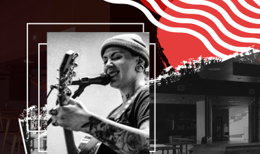 Musician singing with the Warrior Grill in the background