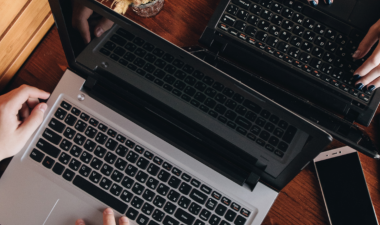 Two computers at a cafe table
