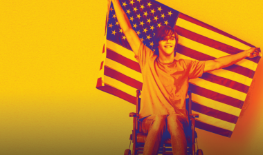 Crip Camp Poster, person in a wheelchair holding a U.S.A. flag