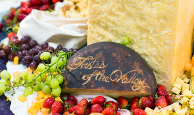 Charcuterie board with &quot;Tastes of the Valley&quot; carved out in a cheese block