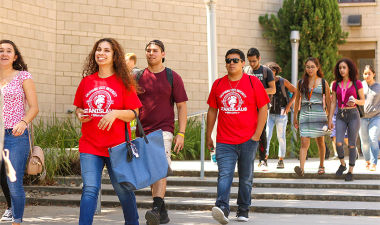 Stanislaus State students walking outdoors on campus.
