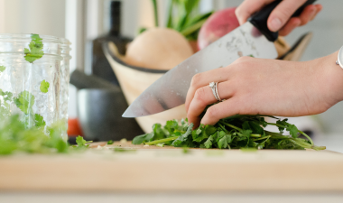 person cutting vegetables with a knife