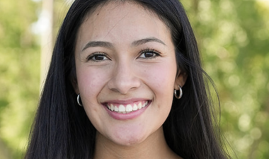 Anahi Lopez holds her award plague.