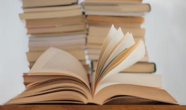 white book on a brown wooden table