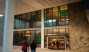 Students walk into the J. Burton Vasche Library.