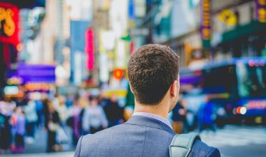 a man looking at a busy street