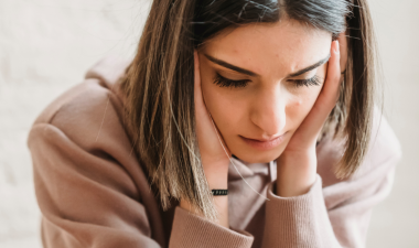 Person with their head in their hands, looking stressed