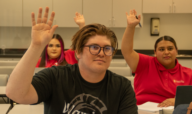 Stan State students in a classroom engaged in learning.