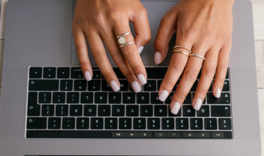 hands typing on a laptop