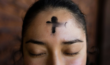 woman with black ash cross on her forehead