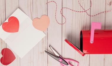 red paper hearts with an envelope and a mail box